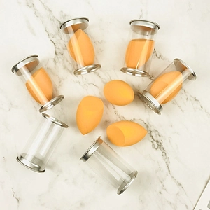 Detailed view of yellow makeup sponges and transparent cylindrical storage containers