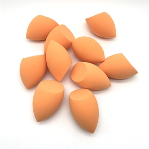 Macro shot of orange non-latex makeup sponges with teardrop and slant-cut shapes