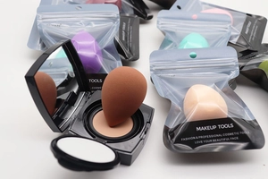 Macro shot of colorful teardrop sponges and cushion foundation in various packaging