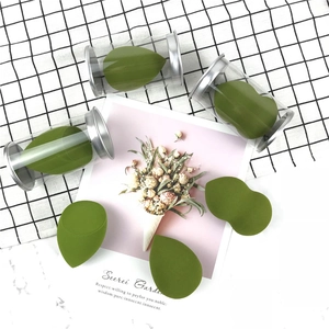 Olive green makeup sponge set with drop and slanted shapes in clear cylinder tubes