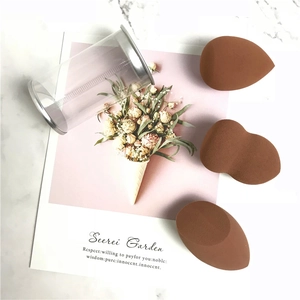 Three brown makeup sponges in water-drop and cut shapes with a clear storage cylinder