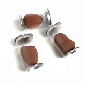 Detailed view of three terracotta makeup sponges in individual clear tubes with silver lids