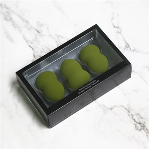 Trois éponges de maquillage vert olive dans un coffret cadeau noir avec fenêtre