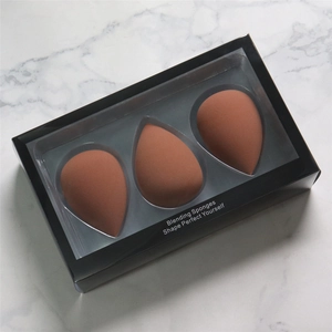 Set of 3 teardrop makeup sponges in brick red, presented in a sleek black window box