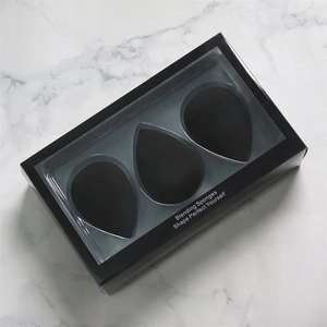 Three-pack makeup sponge set in black display box with transparent window over marble