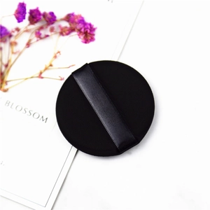 Macro shot of black non-latex cushion puff with satin ribbon and high density texture