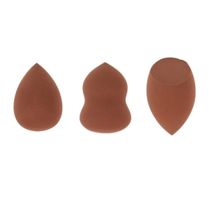 Detailed view of three terracotta makeup sponges in teardrop, gourd, and slanted shapes