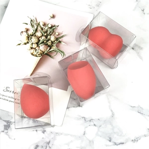 Three coral makeup sponges in heart, teardrop, and slanted shapes with clear cases