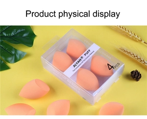 Detailed view of four orange olive-cut makeup sponges in clear branded packaging