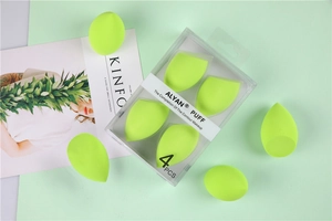 Detail view of four light green makeup sponges with transparent packaging on Kinfolk magazine