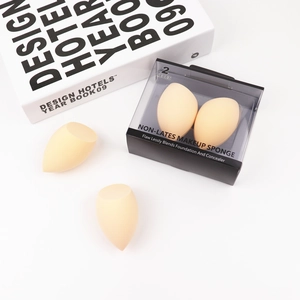 Detail of two non-latex teardrop makeup sponges with slanted edges on white background