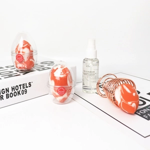 Salmon makeup sponge set with marble texture, 50ml cleanser, and metallic drying stand
