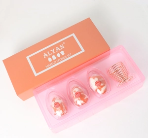 Detailed set of salmon makeup sponges with a rose gold spiral metal holder and packaging