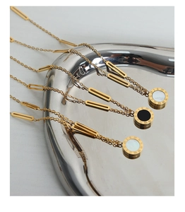 Close-up of titanium steel necklace with Roman numerals and white seashell pendant
