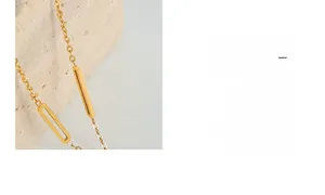Detail of Roman numeral acrylic pendant on gold titanium steel paperclip chain necklace