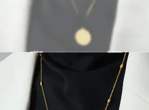 Detail of 18k gold chain necklace with oval beads and elegant minimalist bead accents