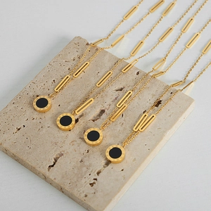 Golden titanium steel chain necklace with roman numeral pendant and black acrylic insert