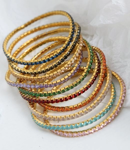 Detail von bunten Tennisarmbändern mit quadratischen Steinen und 18 Karat Vergoldung