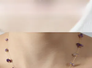 Close-up of golden necklace with irregular purple natural stones on model's neck