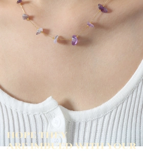 Macro view of gold plated titanium necklace with irregular purple amethyst stone pendant