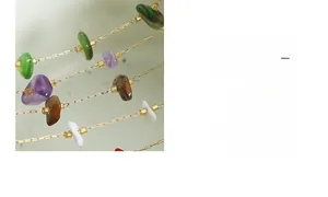 Detailed macro view of 18k gold chain featuring irregular colorful natural gemstones
