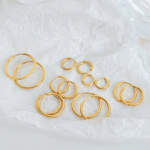 Classic 18k gold plated stainless steel hoop earring set on textured paper