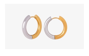 Detail view of two-tone geometric hoop earrings with polished gold and silver finish