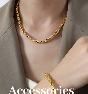 Close-up of gold plated thick twisted curb chain necklace and bracelet jewelry set
