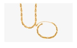 Detailed view of the gold-plated twisted flat link chain necklace and bracelet set