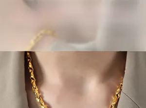 Detail showing gold plated twist chain necklace worn with a professional blazer