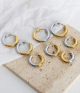 Detailed view of two-tone gold and silver geometric hoop earrings in various sizes