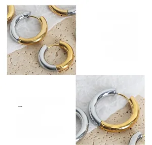 Close-up of geometric hoop earrings in two-tone 18k gold plated titanium steel finish