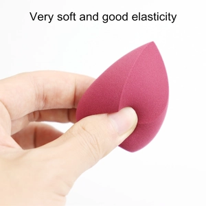 Close-up of soft drop-shaped makeup sponge being pressed to show high elasticity