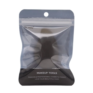 Detail view of the mango-shaped makeup sponge in transparent hanging pouch packaging