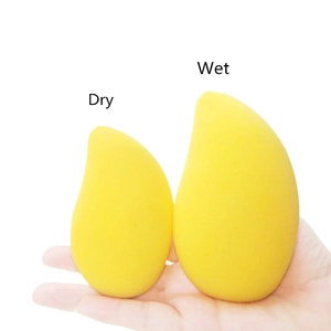 Mango shaped makeup sponge blender showing dry and wet size comparison in hand
