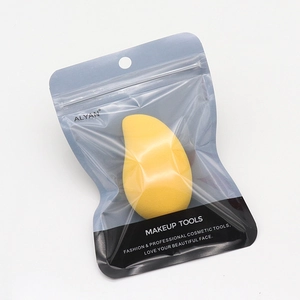 Detail of mango-shaped makeup sponge in portable transparent zipper bag packaging