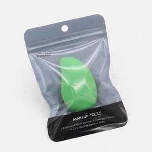 Close-up of green makeup sponge in a translucent zipper bag with a sleek matte finish