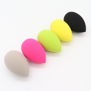 Detail of five teardrop makeup sponges in grey, magenta, green, yellow and black colors