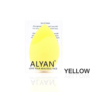 Detail of yellow teardrop makeup sponge in its branded clear box packaging