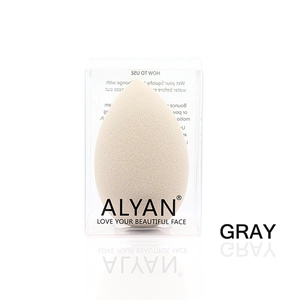 Detail shot of a soft gray teardrop makeup sponge in its clear branded packaging