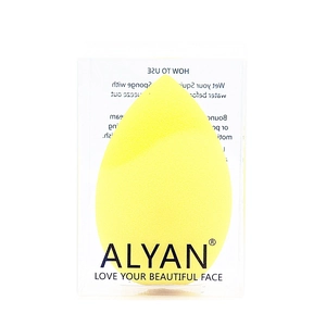 Detail of yellow teardrop makeup sponge in clear packaging with ALYAN branding