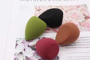Detail of four colorful teardrop makeup sponges with flat edges for precise application