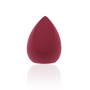 Deep red teardrop makeup sponge with slanted cut and non-latex texture on white background