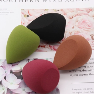 Set of four multi-colored teardrop and cut-edge makeup sponges for versatile application