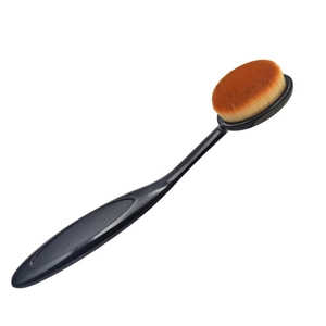 Detail of ergonomic oval foundation brush with soft synthetic bristles and black handle