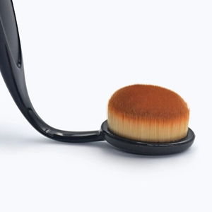 Close-up of dense synthetic bristles and ergonomic black handle of the foundation brush