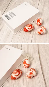 Detailed view of orange marble makeup sponges in teardrop and cut-surface shapes