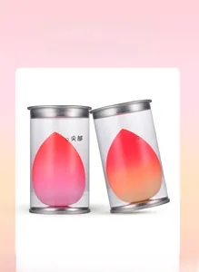 Detail view of gradient makeup sponges in transparent cylindrical tubes with silver lids