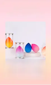 Macro detail of teardrop makeup sponges with clear storage tube and silver metal lid