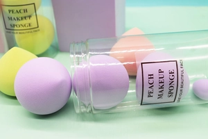 Colorful peach makeup sponge set in transparent jar with pastel purple and yellow blenders